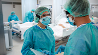 Two medical staff wearing personal protective equipment