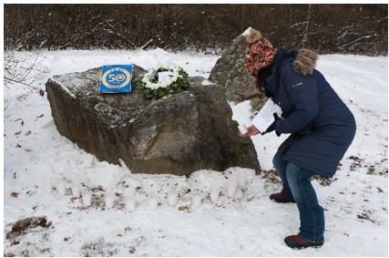 Placing white candles at memorial